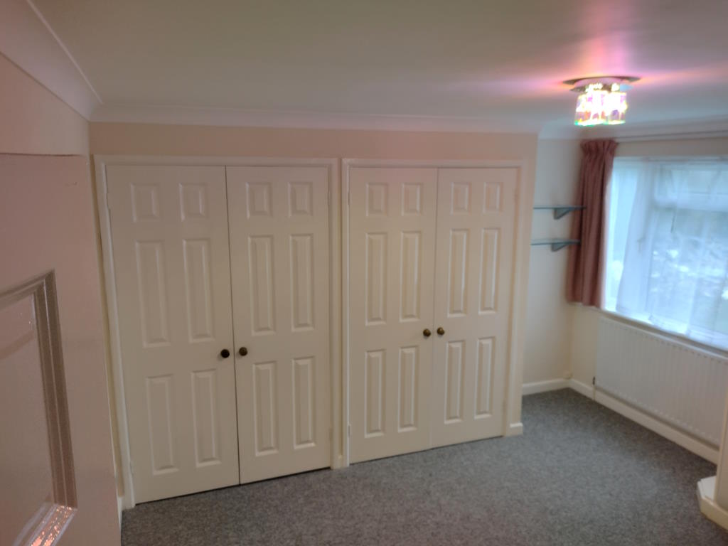 Bedroom showing cupboards